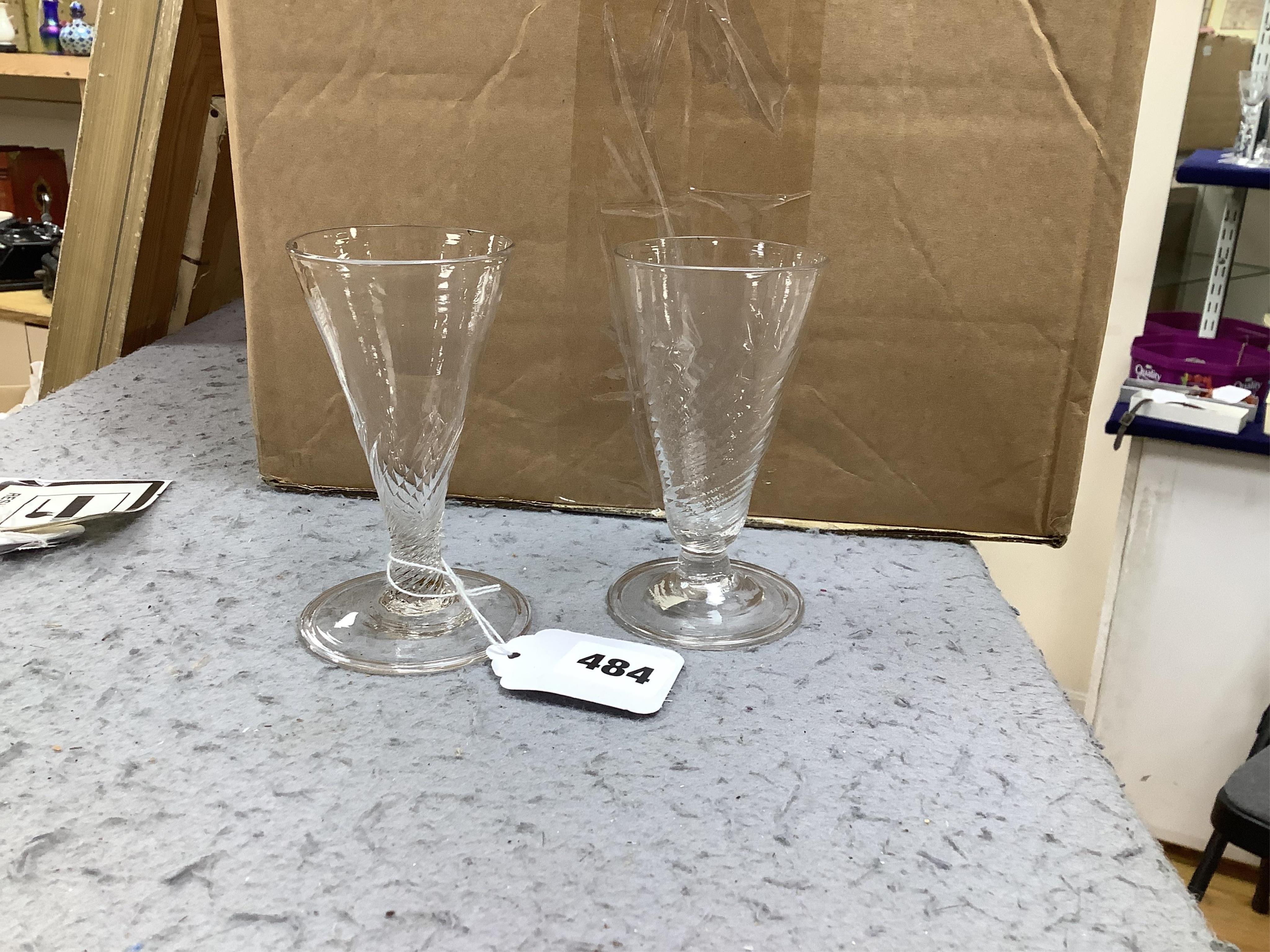 Two late 18th century ale glasses, both with wrythen bowls and folded feet, tallest 12cm. Condition - good
